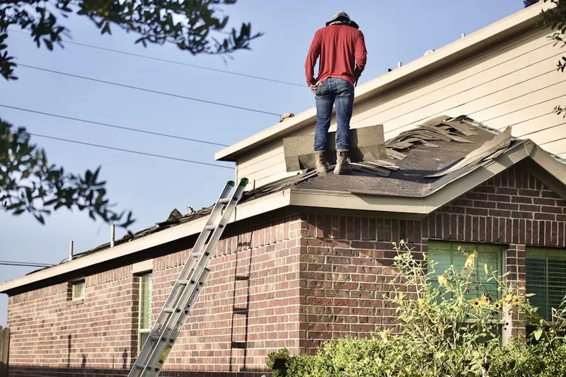 Professional roofer working on a residential roof in Kankakee